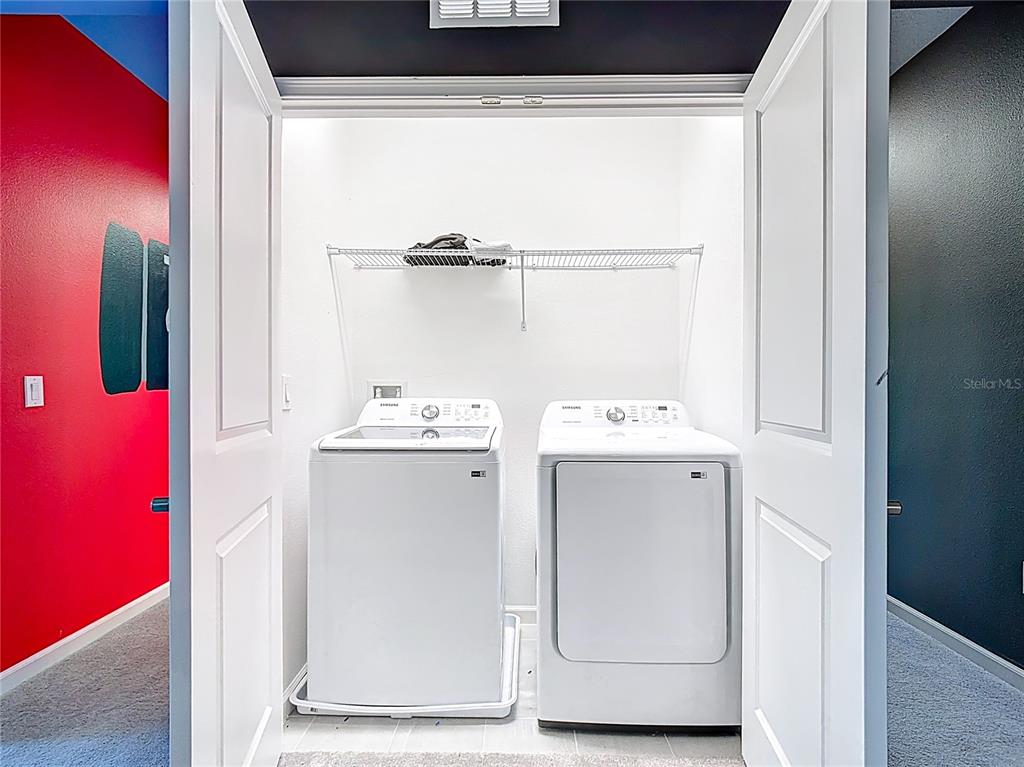 1326 Butterfly Orchid Road Davenport, FL 33837 - Photo 47 of 54 a utility room with dryer and washer