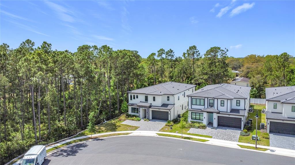 1326 Butterfly Orchid Road Davenport, FL 33837 - Photo 49 of 54 a view of a house with a swimming pool and a yard