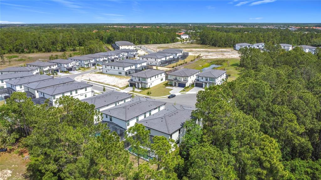 1326 Butterfly Orchid Road Davenport, FL 33837 - Photo 51 of 54 an aerial view of residential houses with outdoor space and lake view