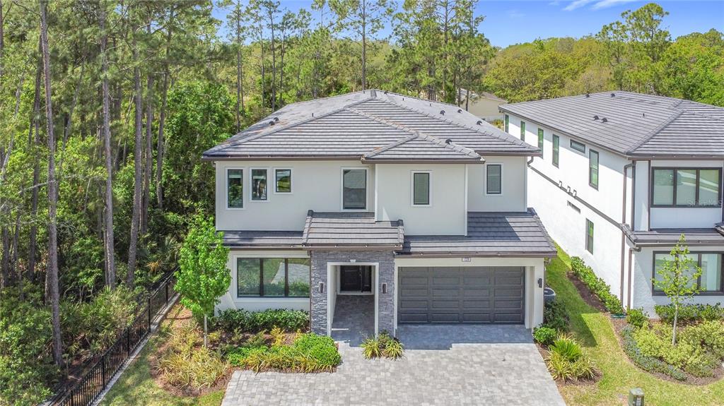 1326 Butterfly Orchid Road Davenport, FL 33837 - Photo 6 of 54 a front view of a house with a garden and plants