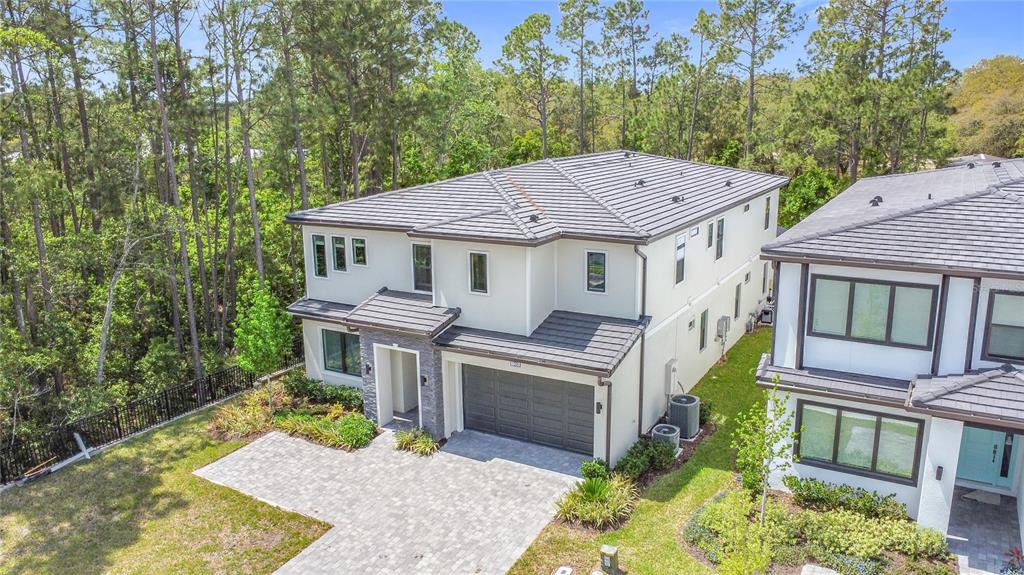 1326 Butterfly Orchid Road Davenport, FL 33837 - Photo 7 of 54 a aerial view of a house with a yard table and chairs