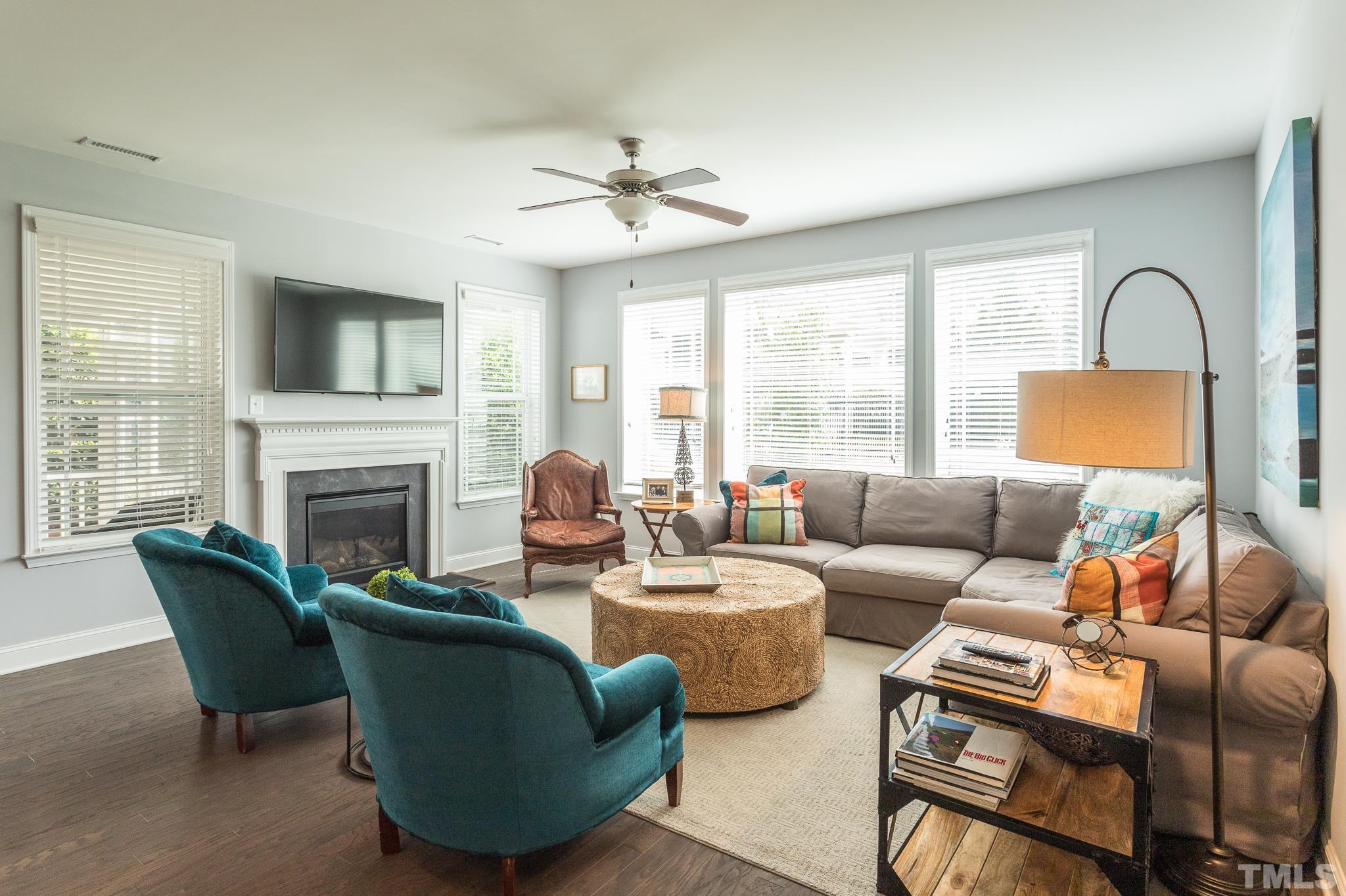 114 Willow View Lane Apex, NC 27539 - Photo 11 of 40 a living room with furniture a fireplace and a large window