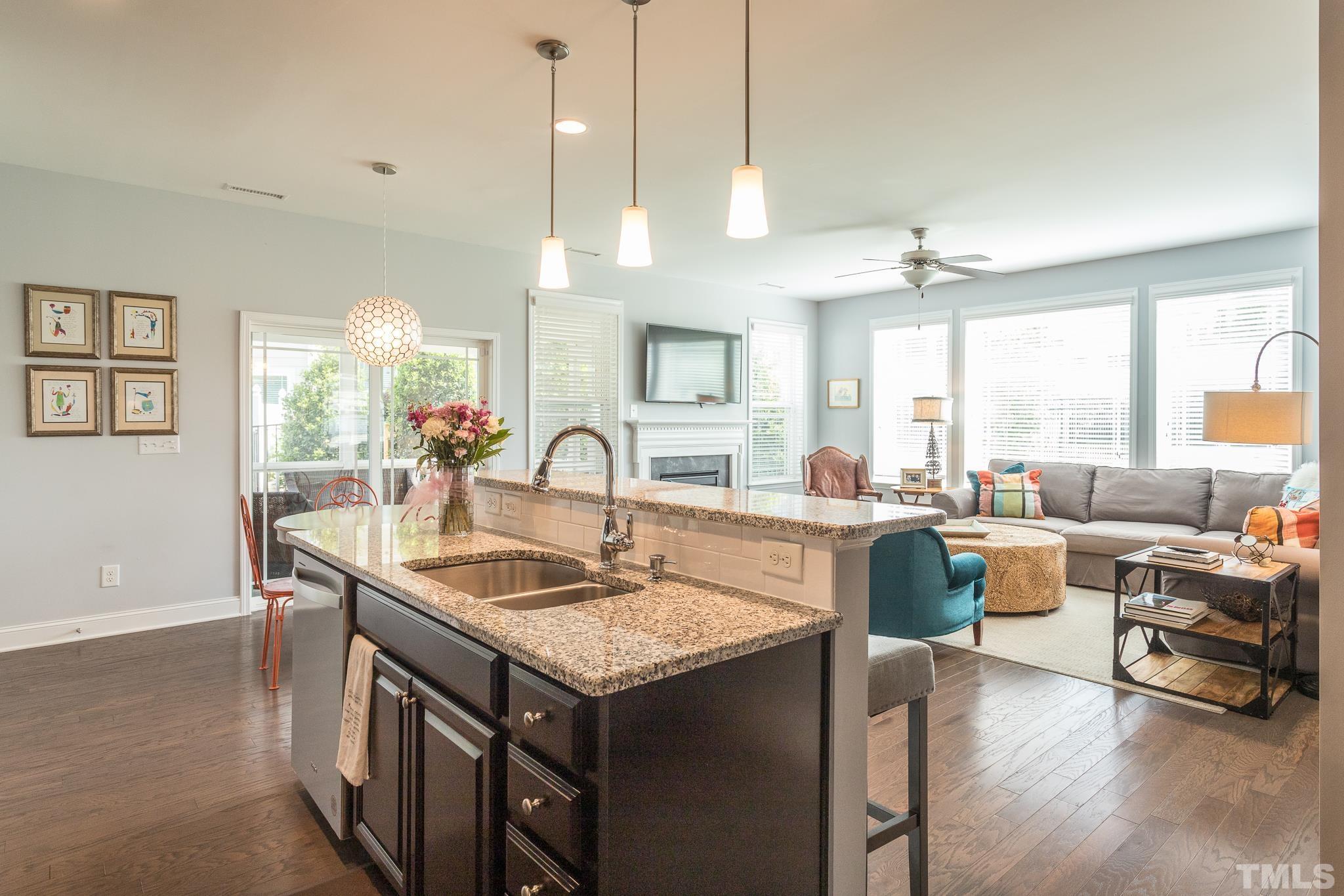 114 Willow View Lane Apex, NC 27539 - Photo 12 of 40 a kitchen with counter top space a sink appliances and living room view