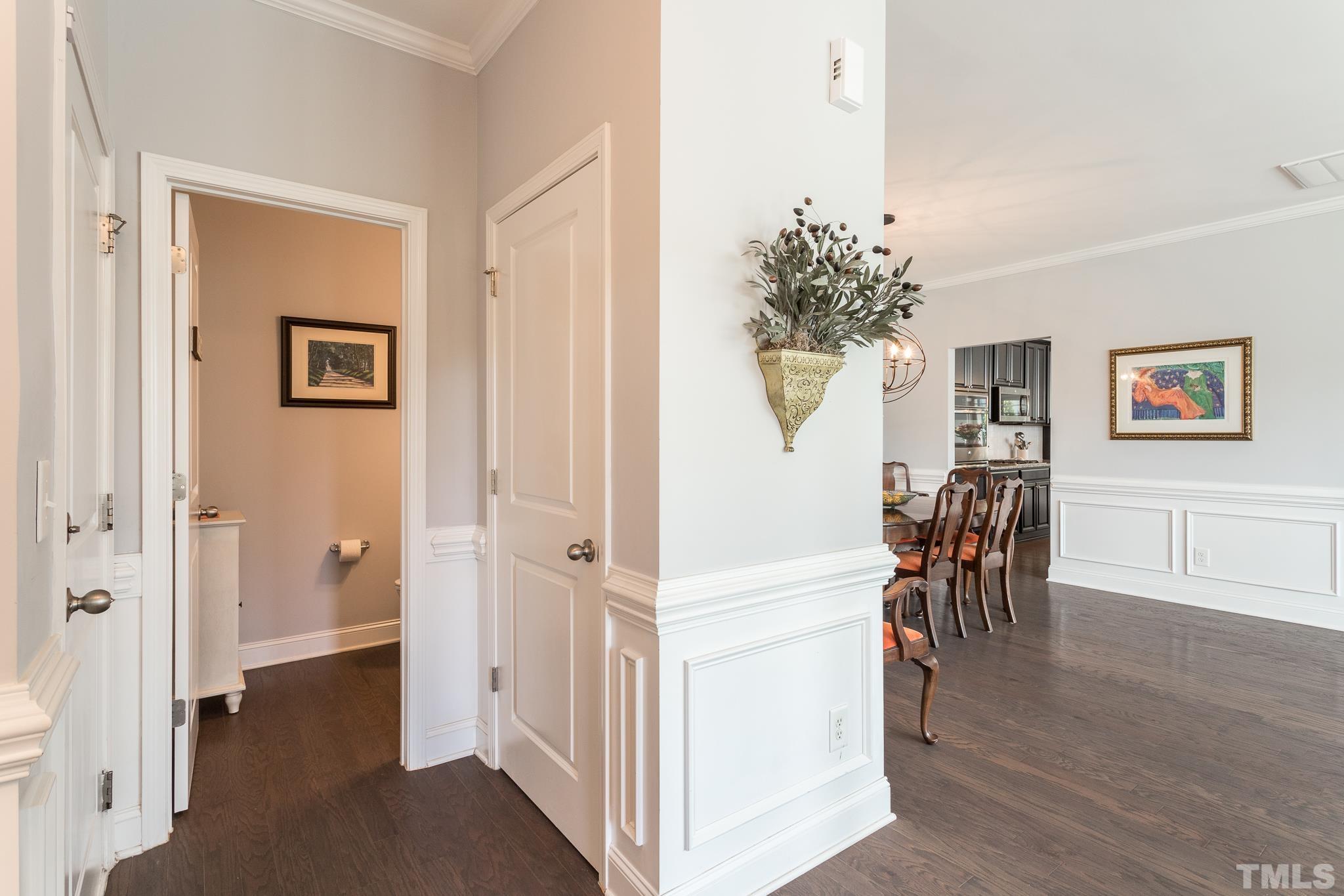 114 Willow View Lane Apex, NC 27539 - Photo 17 of 40 a view of a hallway with wooden floor and a dining room