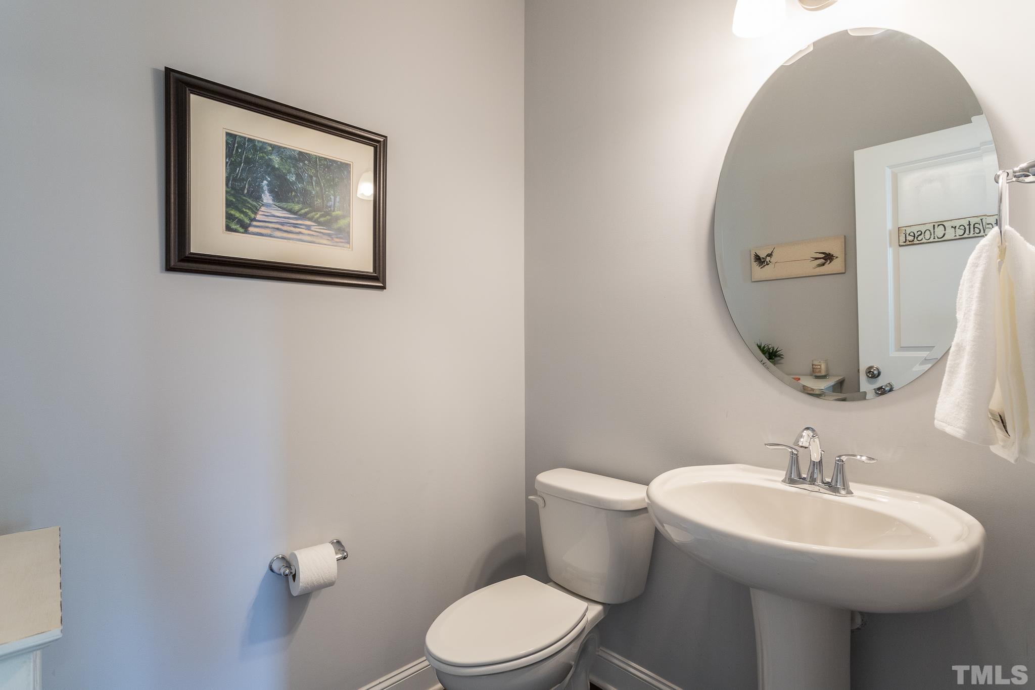114 Willow View Lane Apex, NC 27539 - Photo 18 of 40 a bathroom with a toilet sink and mirror
