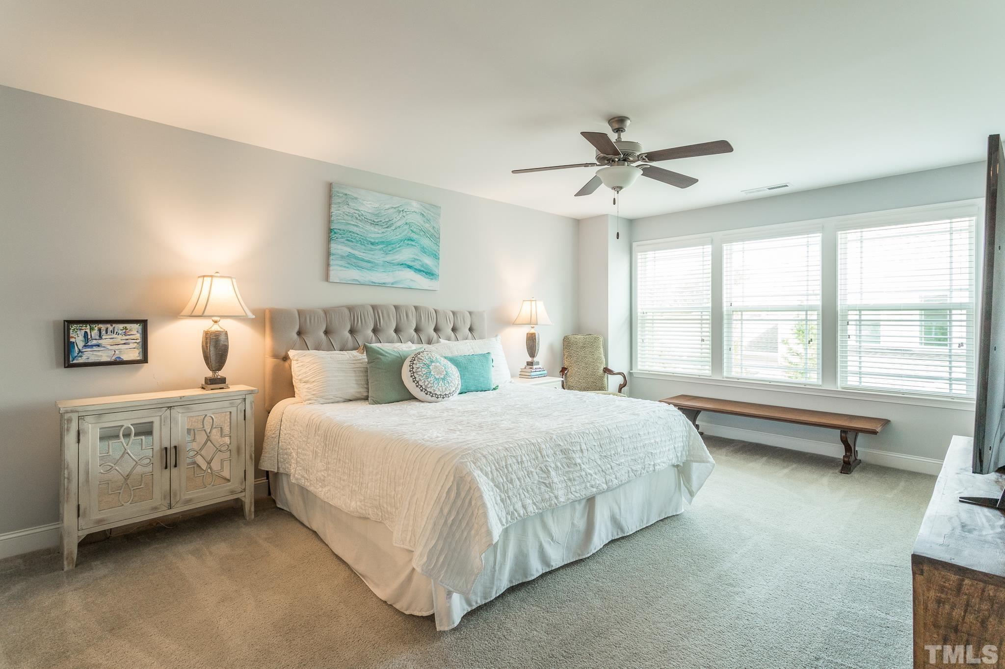 114 Willow View Lane Apex, NC 27539 - Photo 21 of 40 a bedroom with a bed dresser and a window