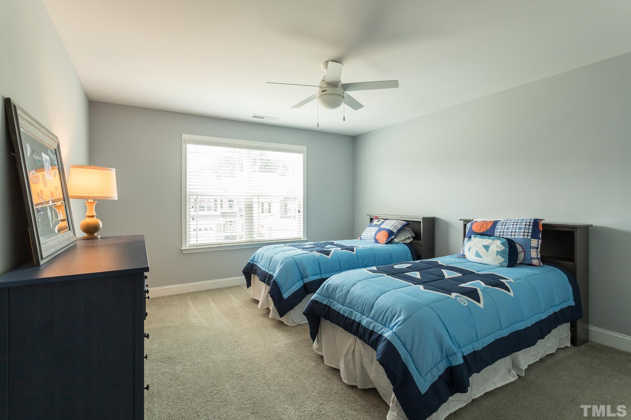 114 Willow View Lane Apex, NC 27539 - Photo 27 of 40 a bedroom with two beds and a window