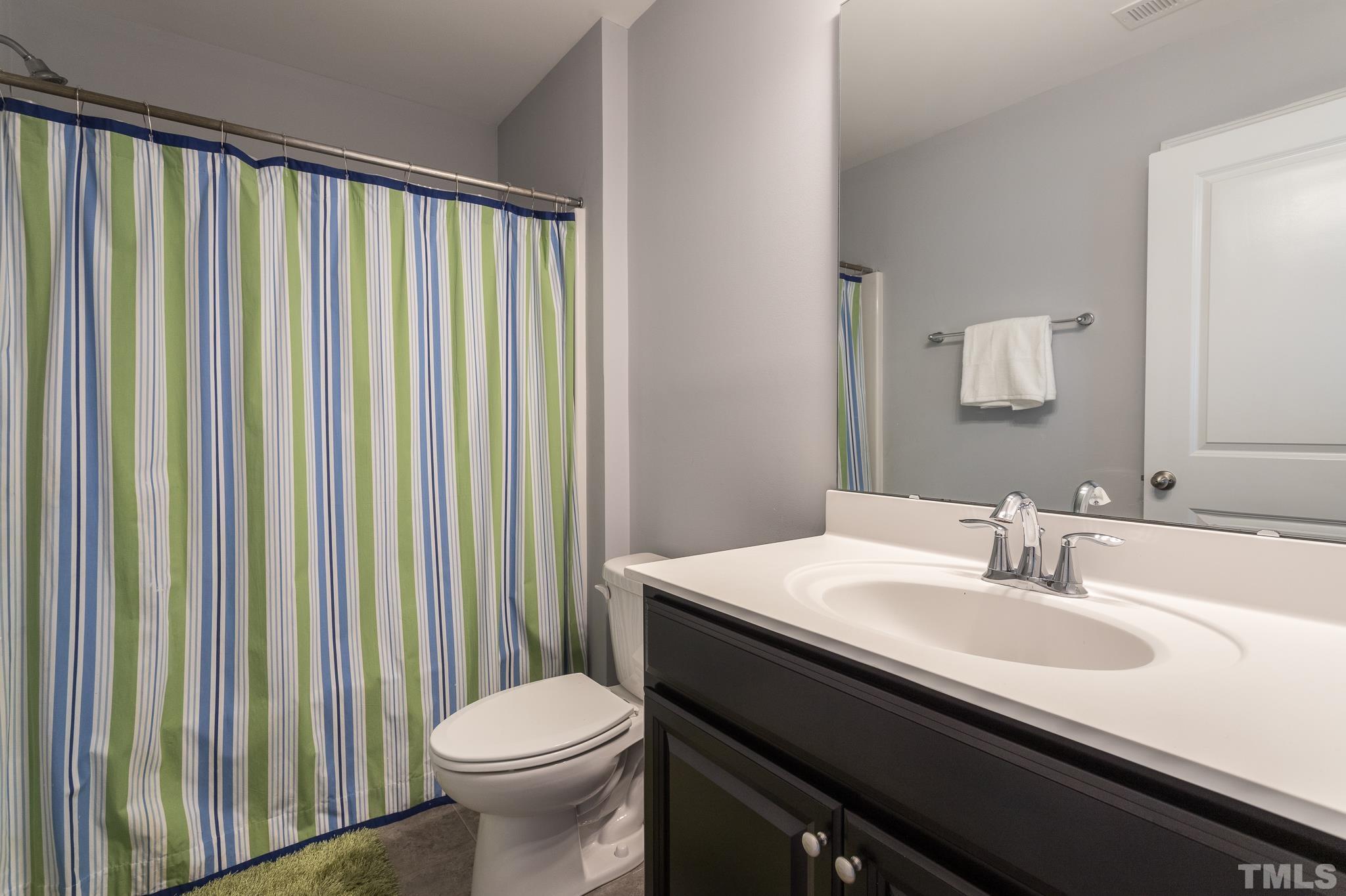 114 Willow View Lane Apex, NC 27539 - Photo 29 of 40 a bathroom with a sink a toilet and a mirror