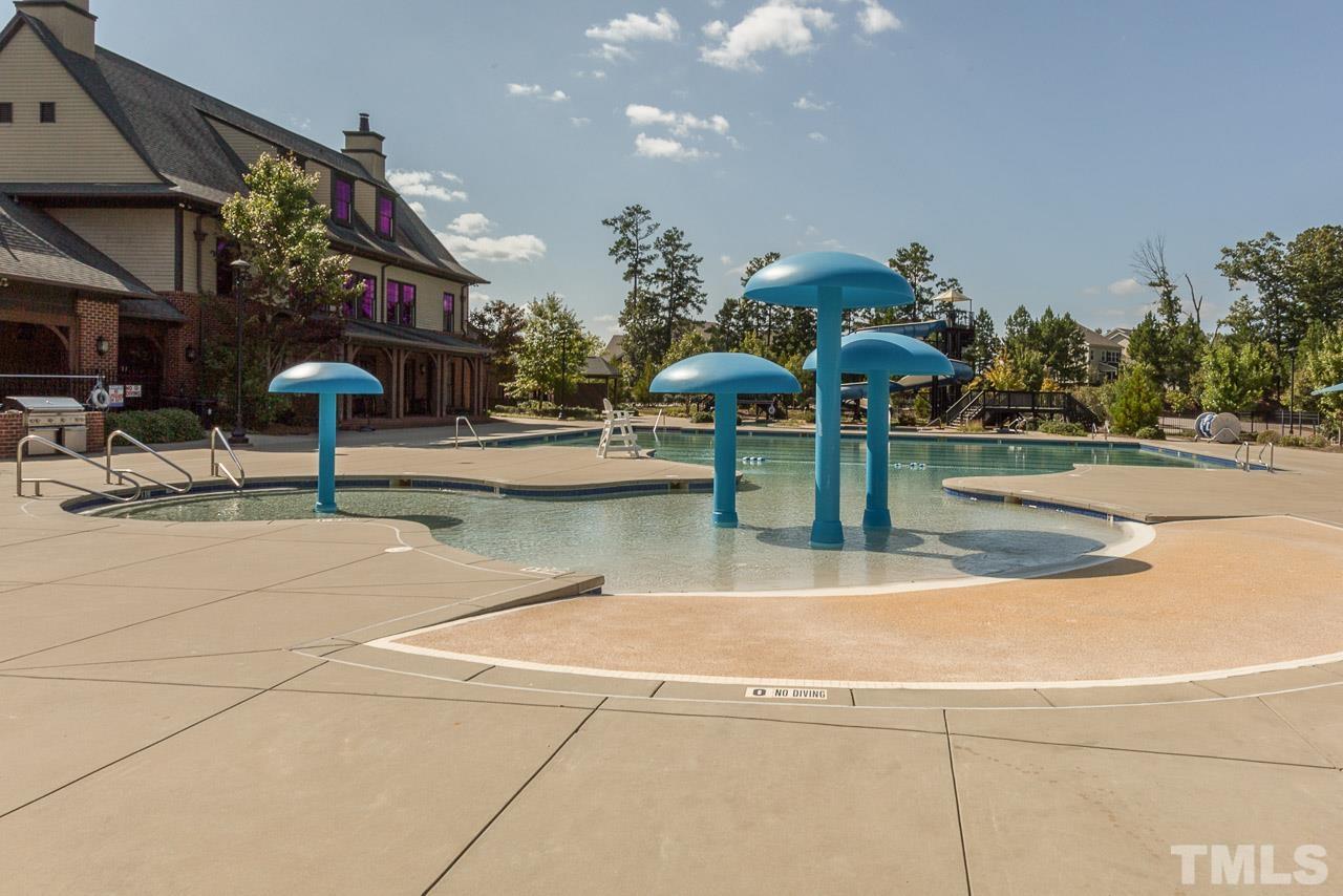 114 Willow View Lane Apex, NC 27539 - Photo 36 of 40 a view of a swimming pool with a bench in front of house