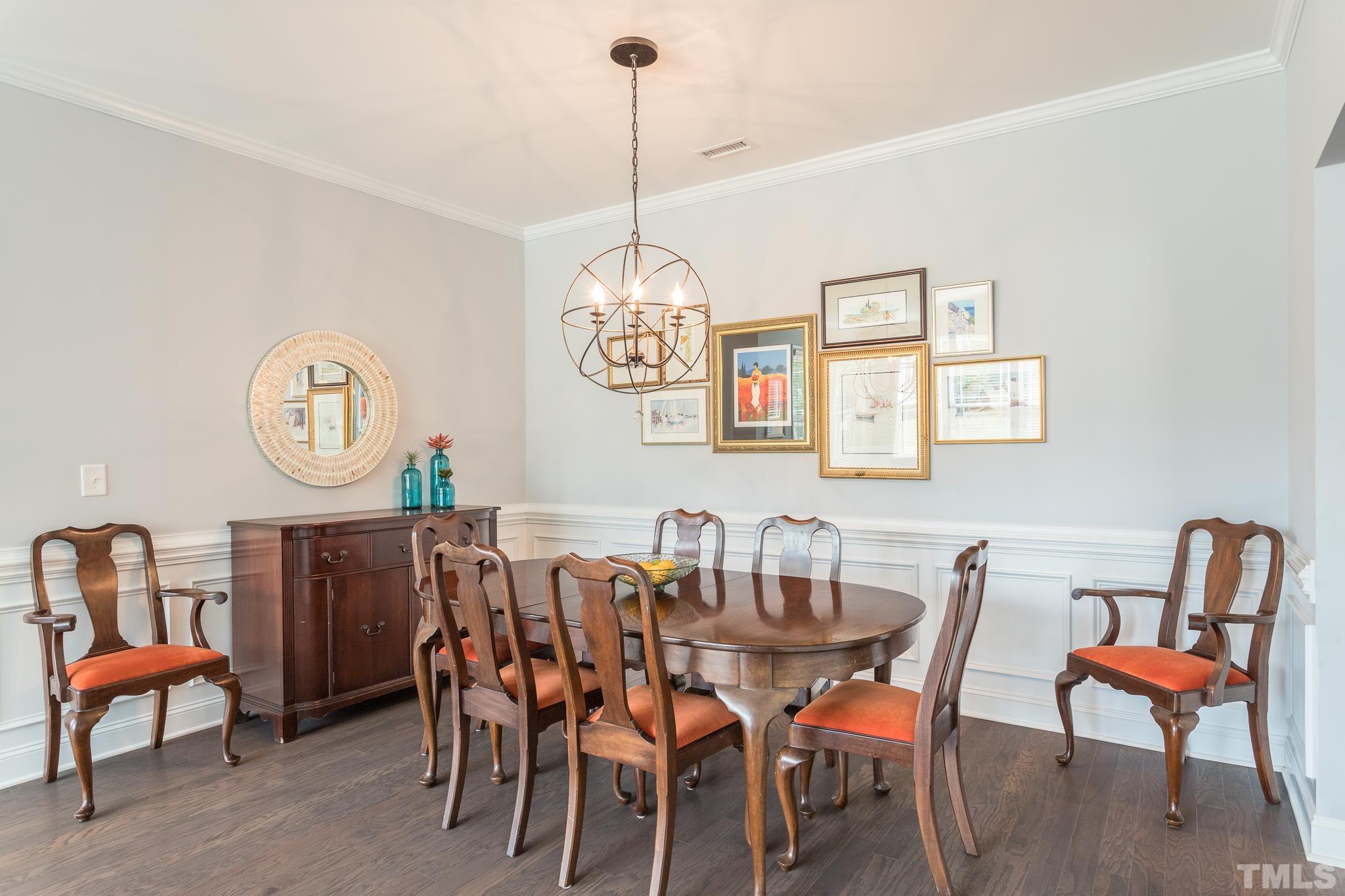 114 Willow View Lane Apex, NC 27539 - Photo 8 of 40 a view of a dining room with furniture a chandelier and wooden floor