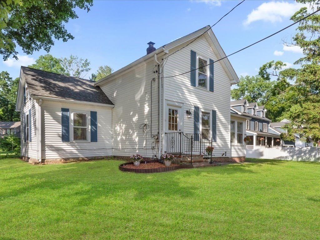 21 Ellis Street Framingham, MA 01701 - Photo 1 of 40 a front view of a house with a yard