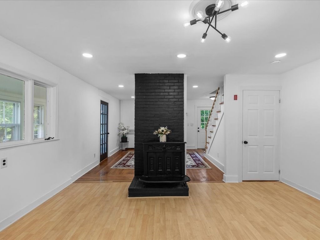 21 Ellis Street Framingham, MA 01701 - Photo 18 of 40 a view of a hallway with a potted plant and wooden floor