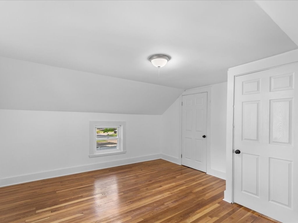 21 Ellis Street Framingham, MA 01701 - Photo 27 of 40 an empty room with wooden floor and windows