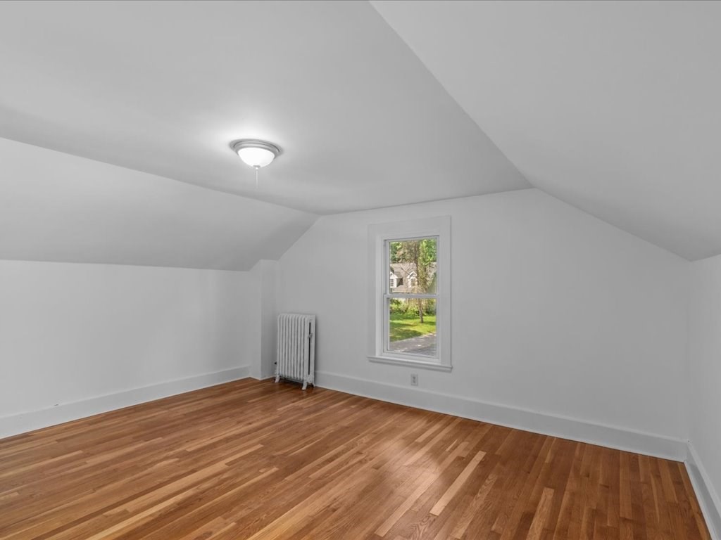 21 Ellis Street Framingham, MA 01701 - Photo 31 of 40 an empty room with a window and wooden floor
