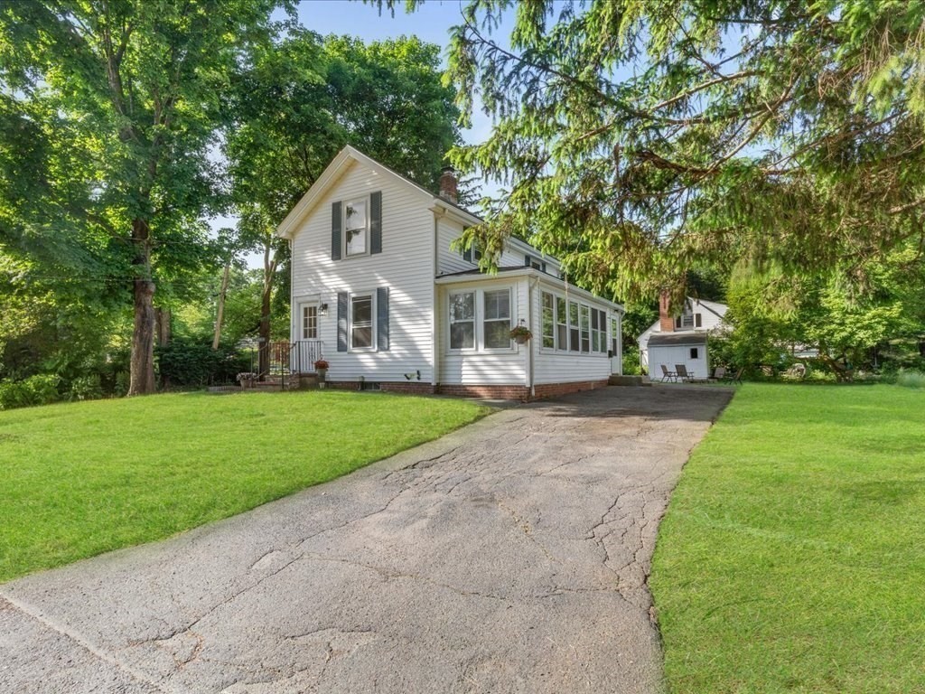 21 Ellis Street Framingham, MA 01701 - Photo 4 of 40 a front view of a house with garden and trees