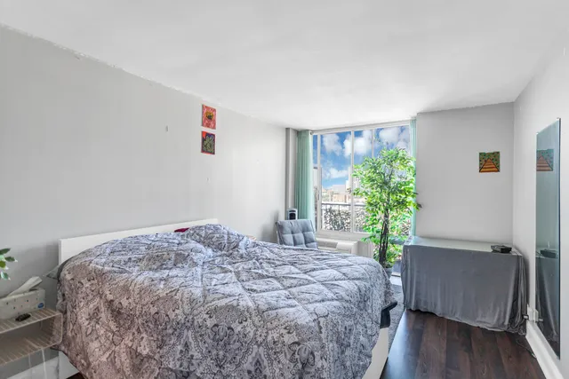 a bedroom with a bed and a potted plant