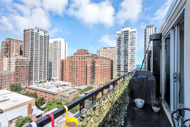 a view of city from balcony with outdoor seating