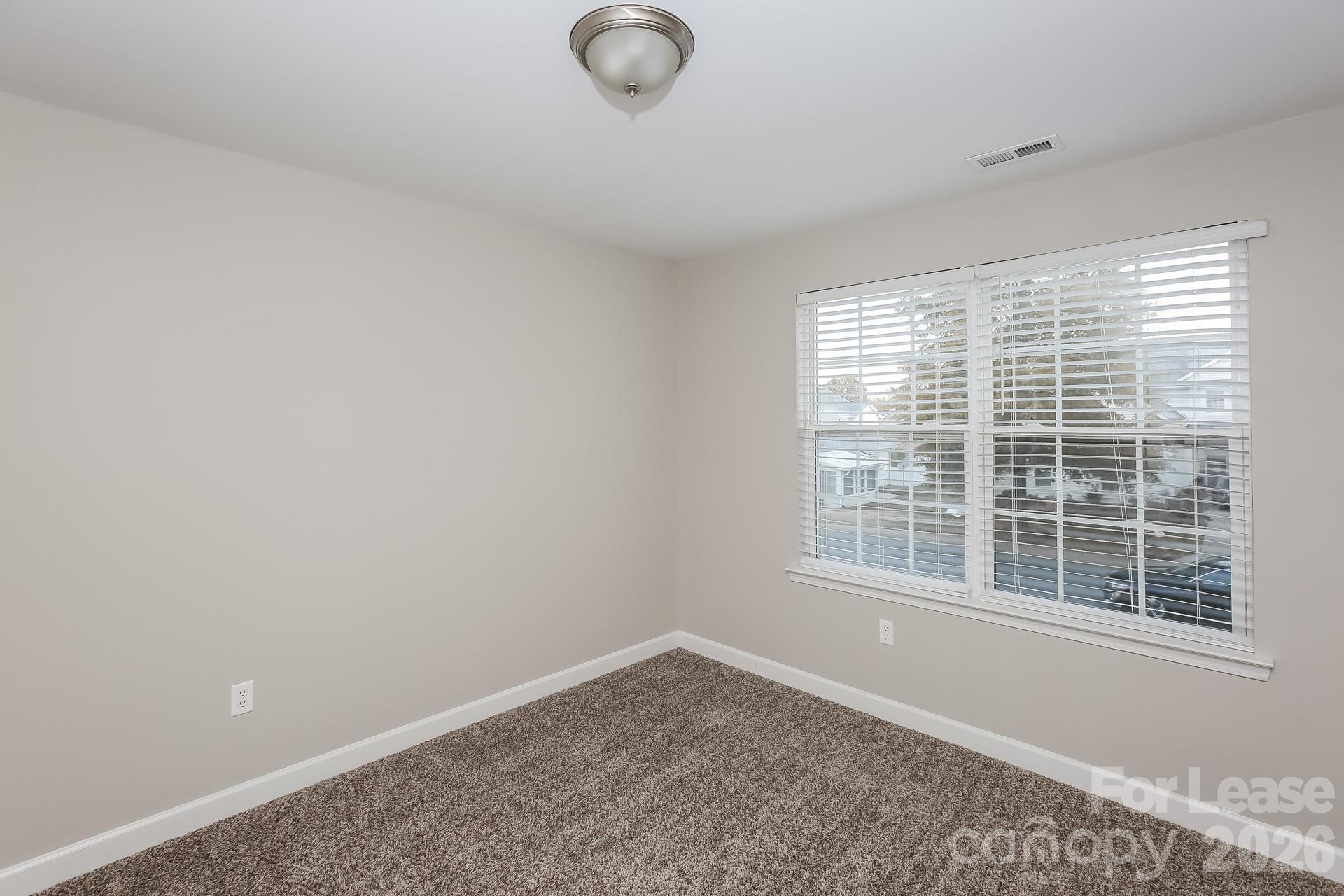 8812 Cornwall Street Locust, NC 28097 - Photo 10 of 15 a view of empty room with windows