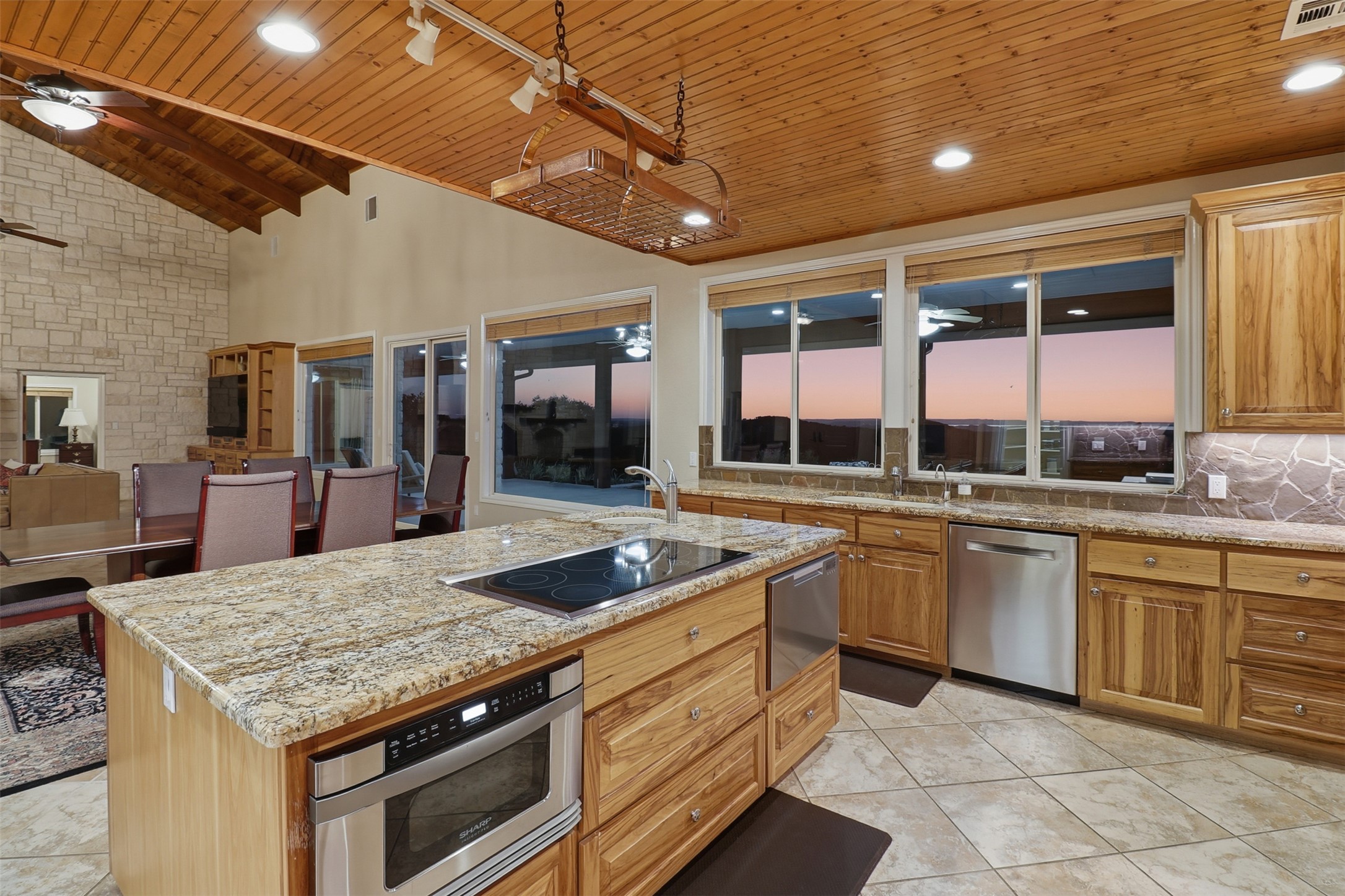 450 Threadgill Ranch Road Burnet, TX 78611 - Photo 30 of 33 a kitchen with stainless steel appliances granite countertop stove top oven and cabinets