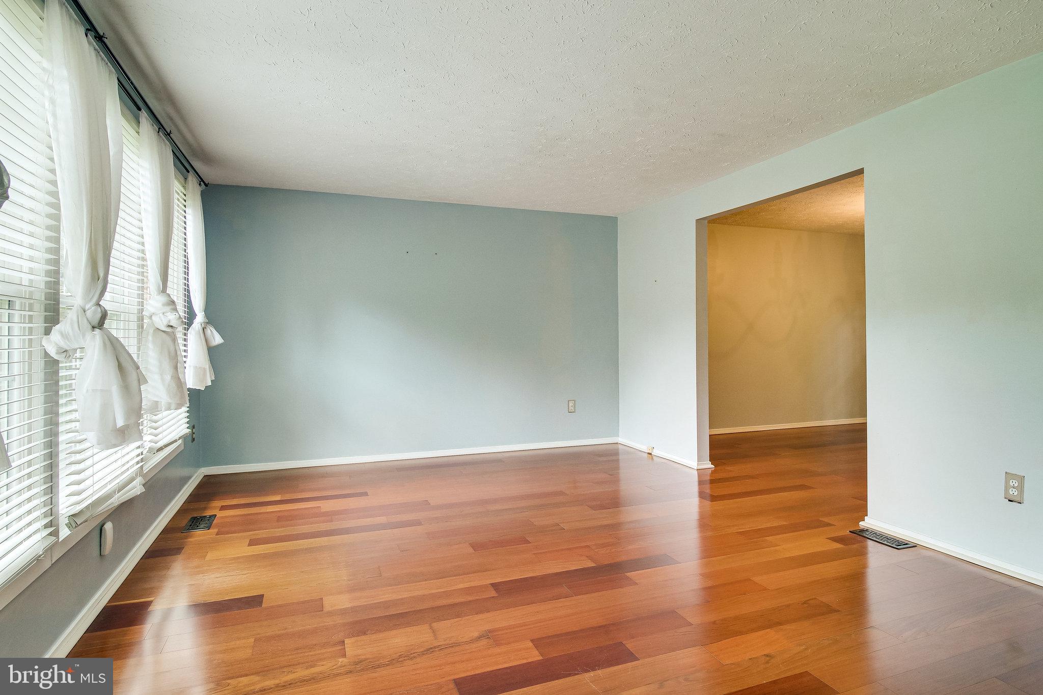 8301 Old Tree Court Springfield, VA 22153 - Photo 6 of 30 Formal living room with gleaming wood floors