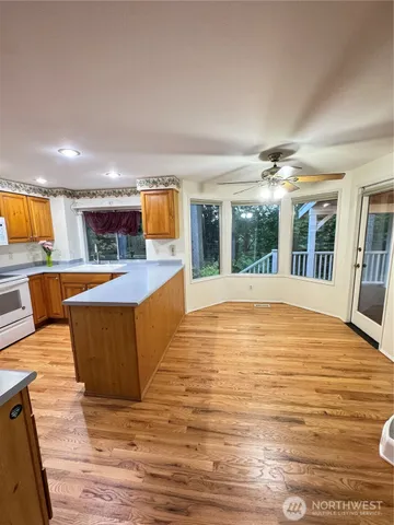 a large swimming pool that has lawn chairs and a wooden floor