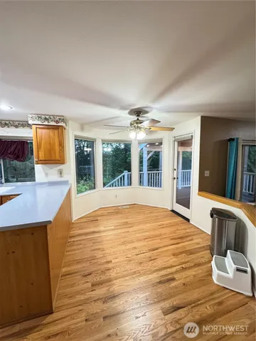 a view of an empty room with a fireplace and a window