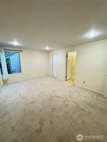a bathroom with a tub sink and mirror