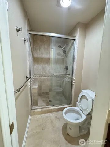 an empty room with a ceiling fan and window