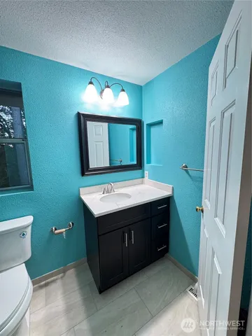 a bathroom with a sink mirror toilet and shower