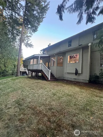 a view of a house with a yard and sitting area