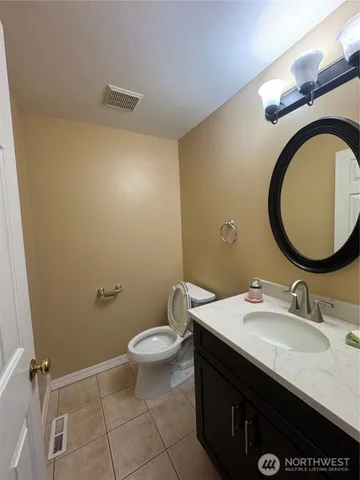 a bathroom with a sink mirror vanity and a toilet