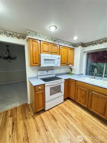 a kitchen with stainless steel appliances granite countertop a sink and cabinets