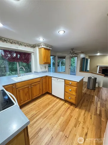 a kitchen with stainless steel appliances granite countertop a sink and a wooden cabinets