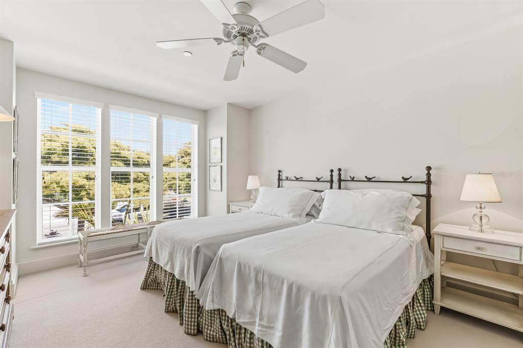 312 Baily Street Boca Grande, FL 33921 - Photo 15 of 41 a bedroom with a large bed and a chandelier