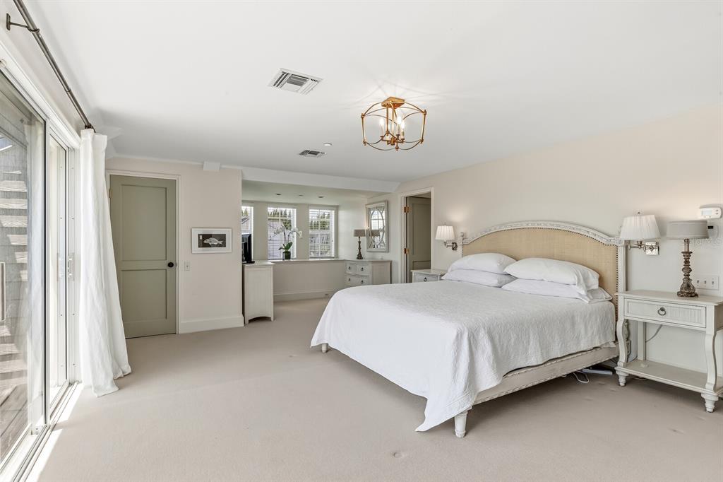 312 Baily Street Boca Grande, FL 33921 - Photo 19 of 41 a spacious bedroom with a bed and a table