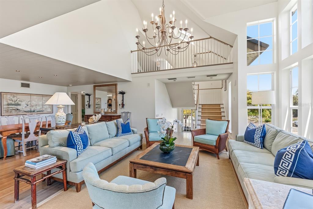 312 Baily Street Boca Grande, FL 33921 - Photo 2 of 41 a living room with furniture and a chandelier