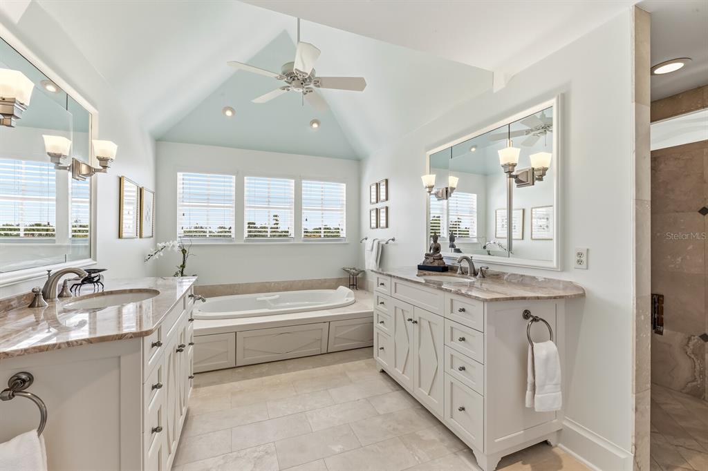 312 Baily Street Boca Grande, FL 33921 - Photo 22 of 41 a spacious bathroom with a double vanity sink a large mirror and a bathtub