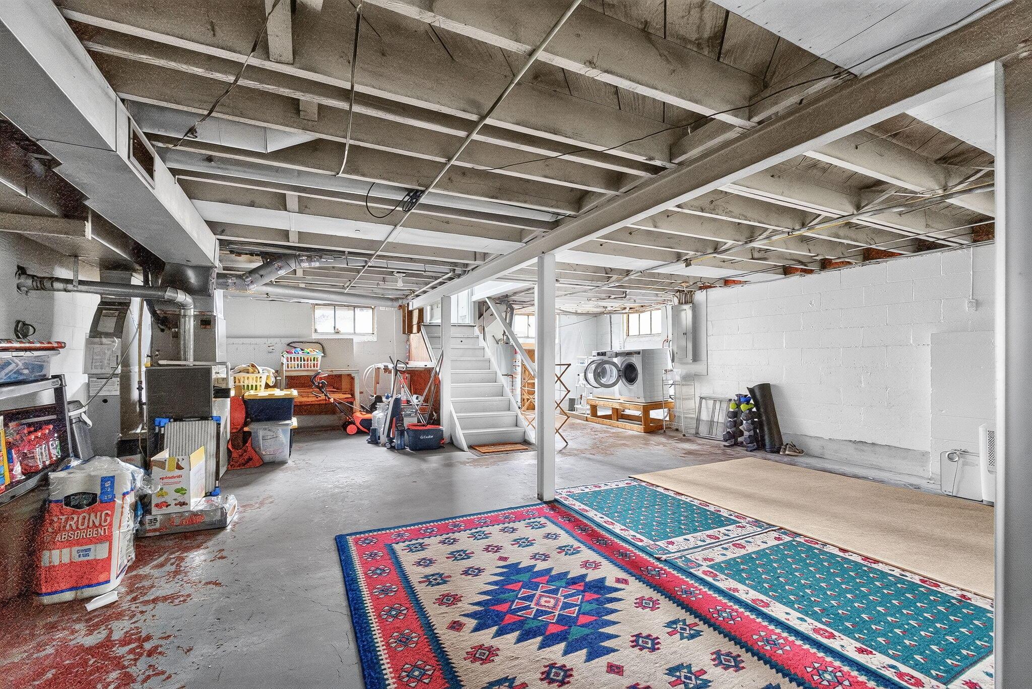 492 Wetmore Road Columbus, OH 43214 - Photo 37 of 55 Spacious unfinished basement offering extensive possibilities for customization, featuring exposed ceiling joists, concrete flooring, and multiple window units providing natural light