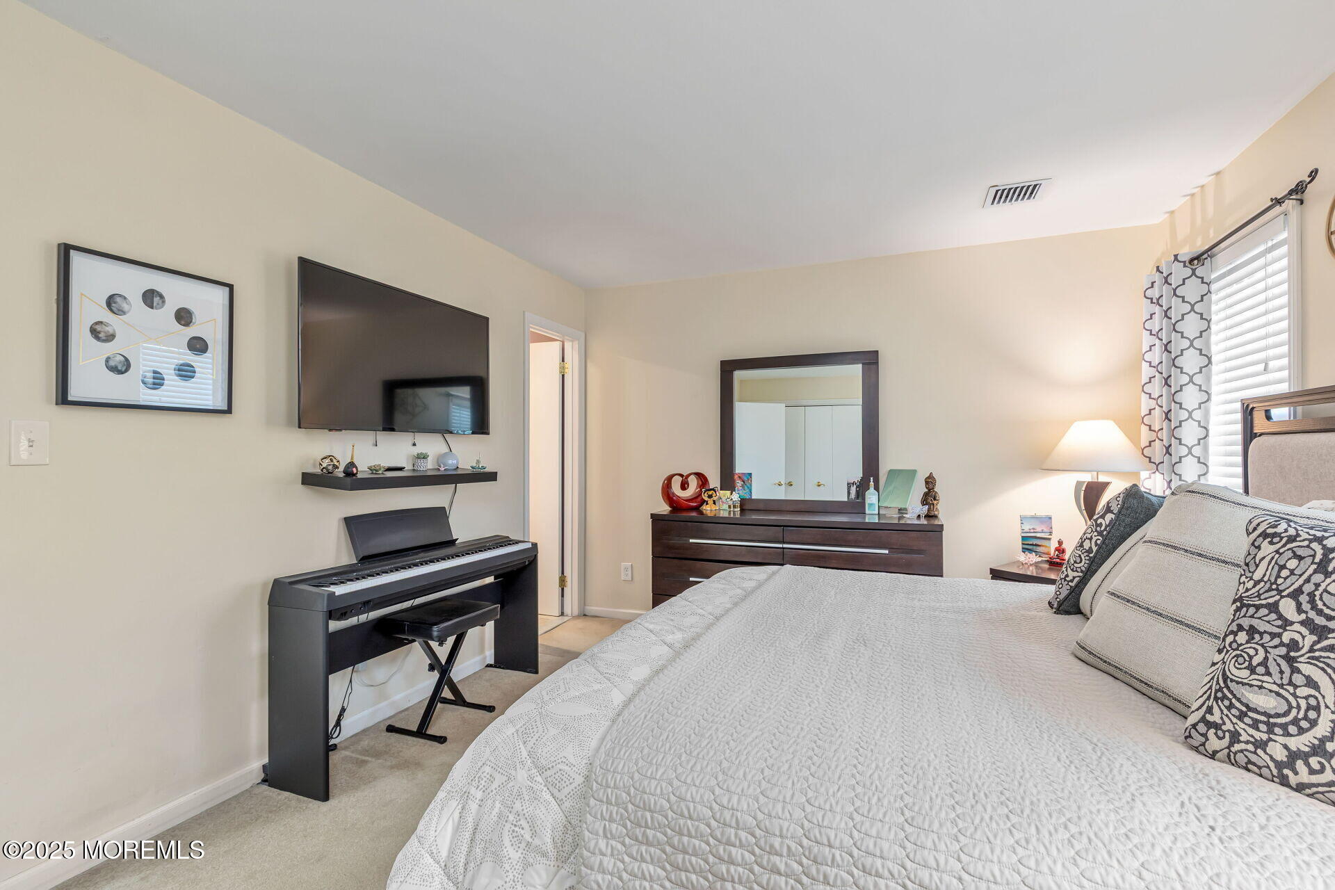 60 County Road, Unit F32 Cliffwood, NJ 07721 - Photo 14 of 31 a bedroom with a bed and a flat screen tv