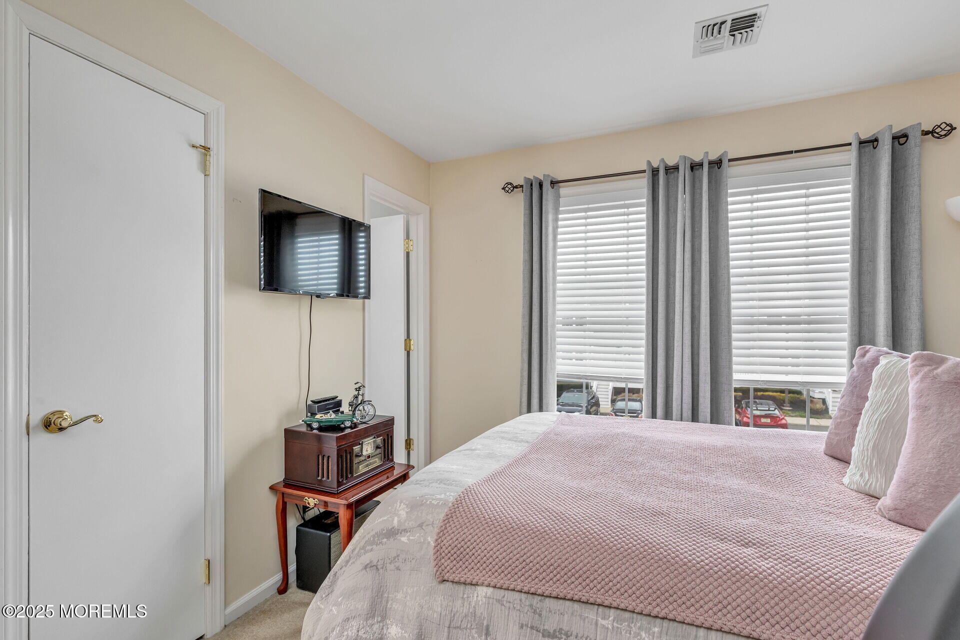 60 County Road, Unit F32 Cliffwood, NJ 07721 - Photo 20 of 31 a bedroom with a bed a television and a window