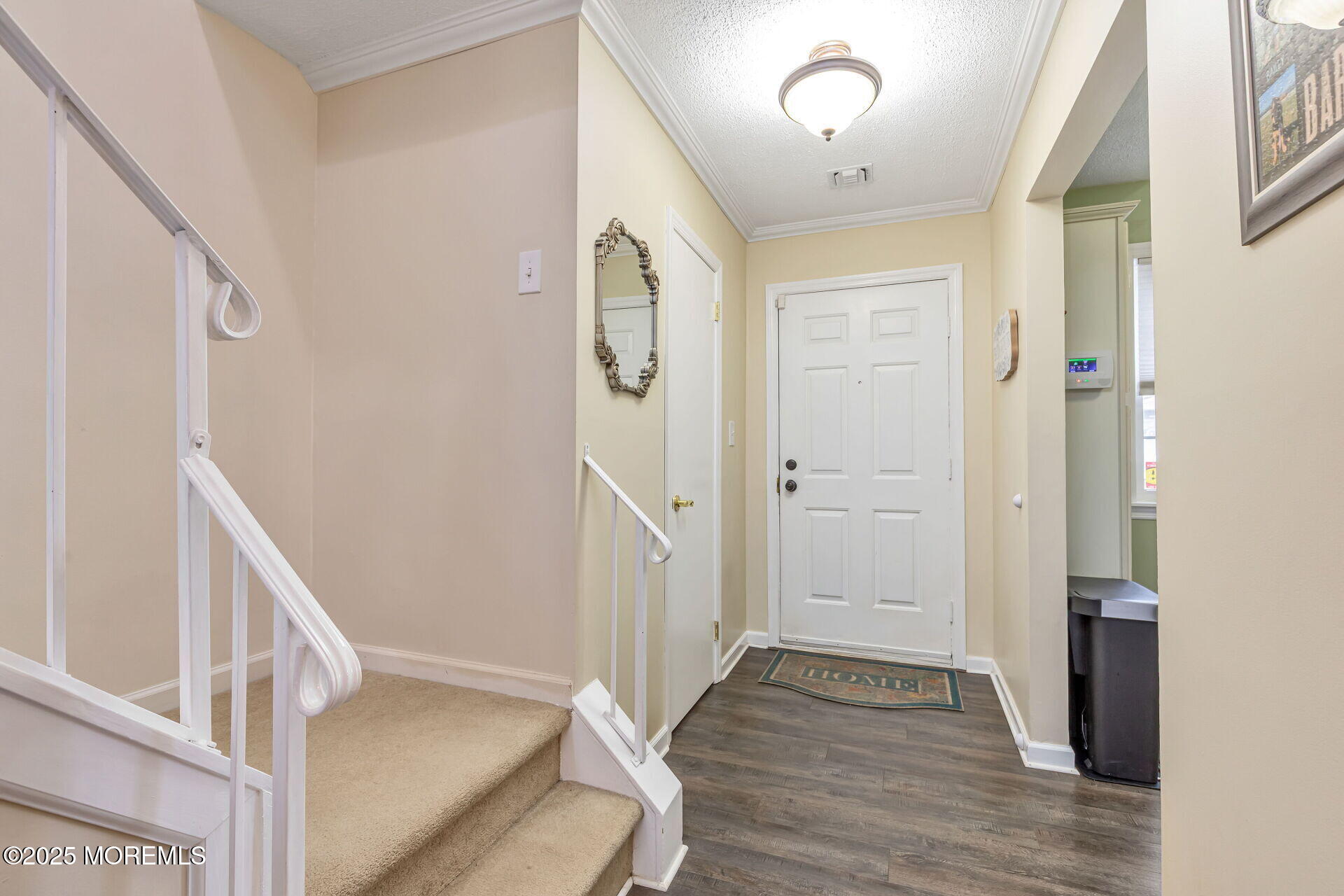60 County Road, Unit F32 Cliffwood, NJ 07721 - Photo 2 of 31 a view of a hallway with wooden floor and staircase