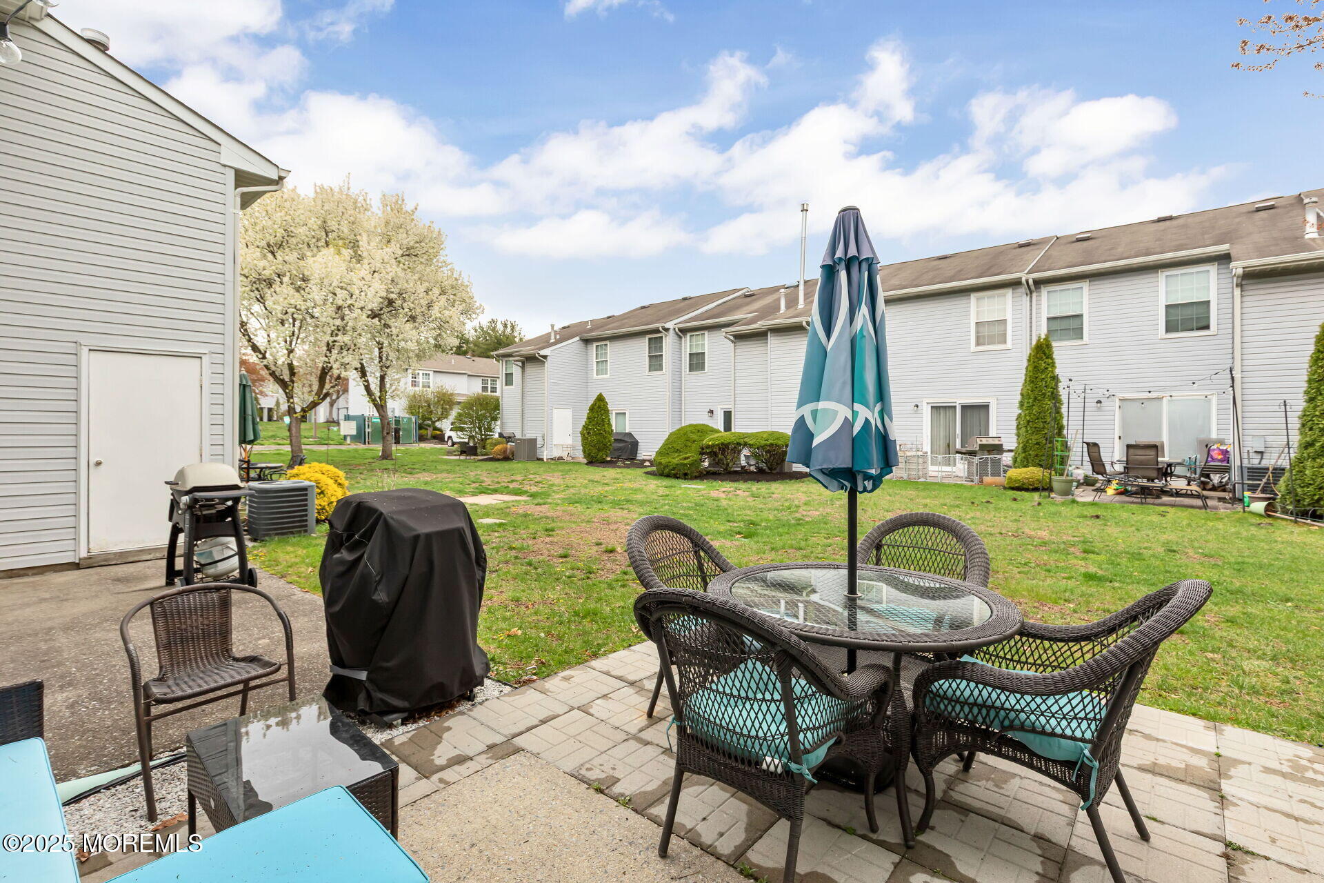 60 County Road, Unit F32 Cliffwood, NJ 07721 - Photo 23 of 31 a patio with table and chairs and a barbeque