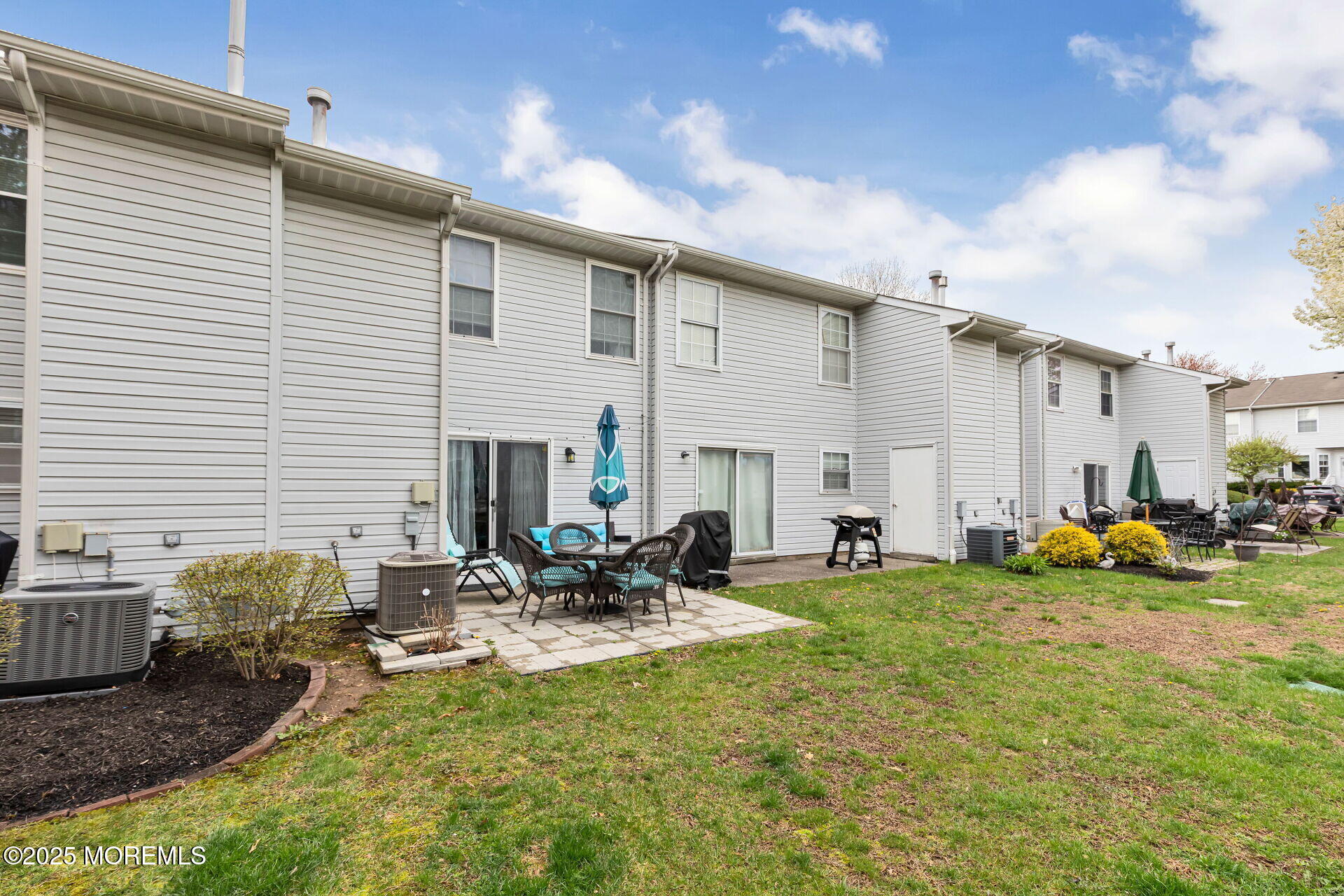 60 County Road, Unit F32 Cliffwood, NJ 07721 - Photo 27 of 31 a row of table and chairs in front of house