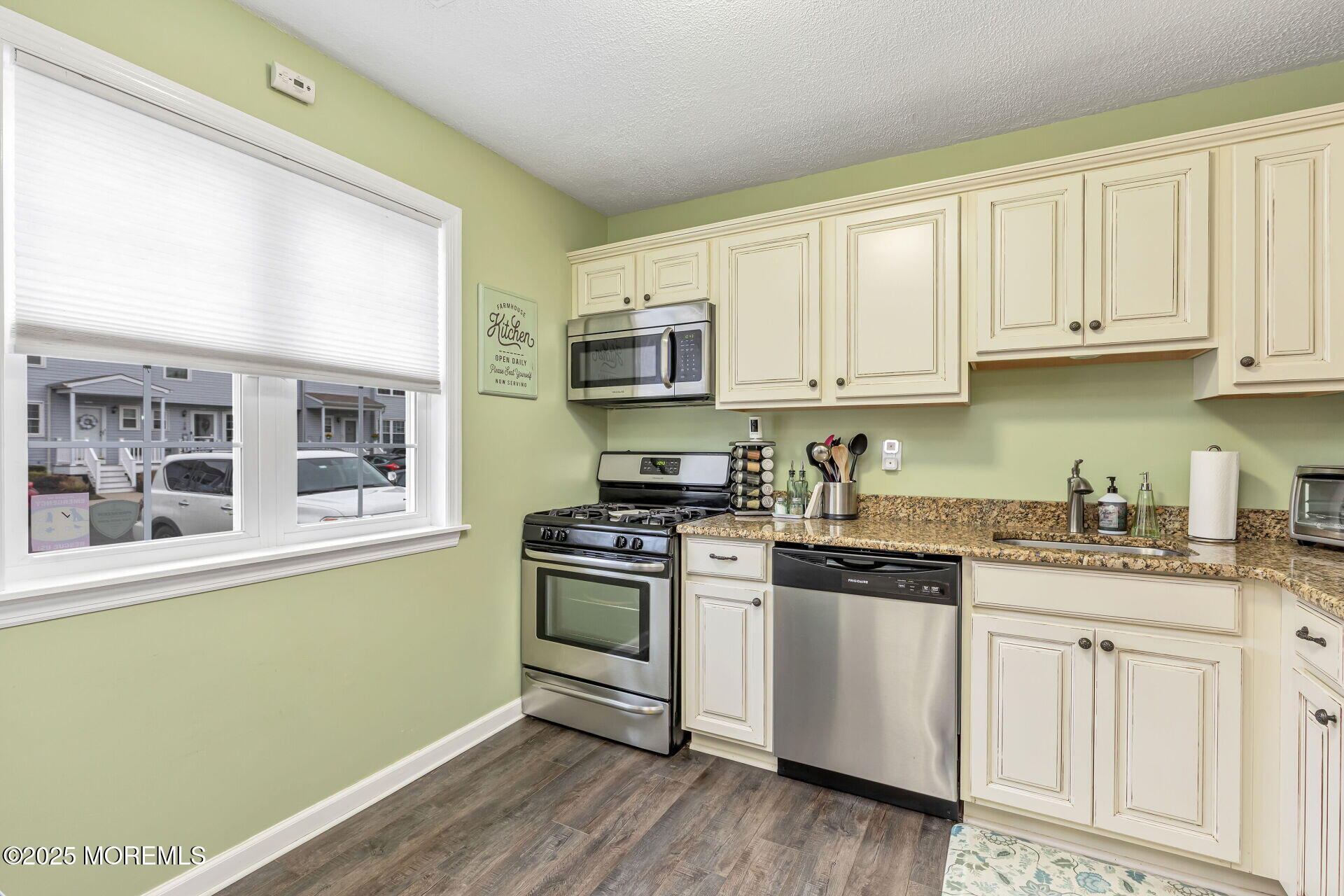 60 County Road, Unit F32 Cliffwood, NJ 07721 - Photo 3 of 31 a kitchen with granite countertop wooden cabinets and a stove