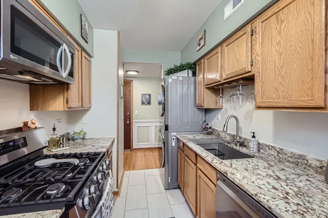 a kitchen with stainless steel appliances granite countertop a stove and a sink