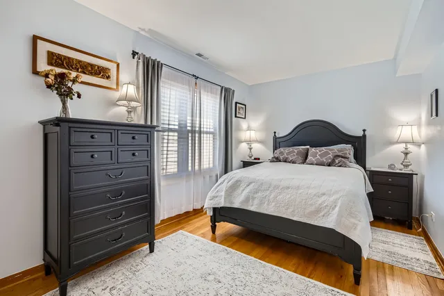 a bedroom with a bed and a dresser