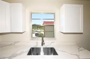 a kitchen with a sink and a window