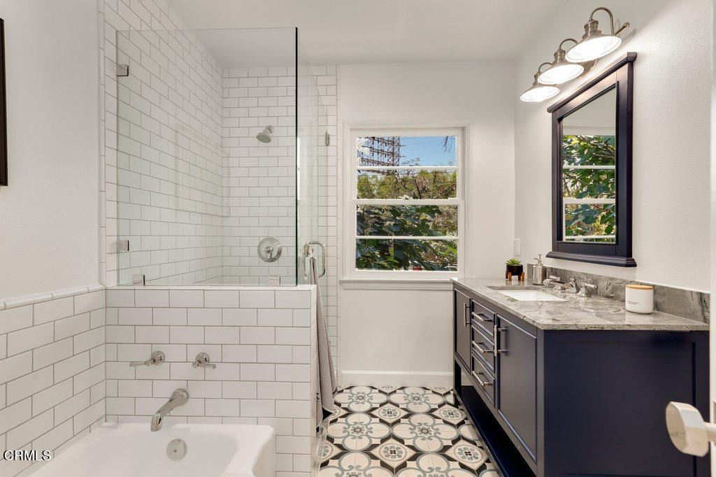 1323 Brampton Road Los Angeles, CA 90041 - Photo 16 of 44 a bathroom with a sink a large mirror and a bathtub