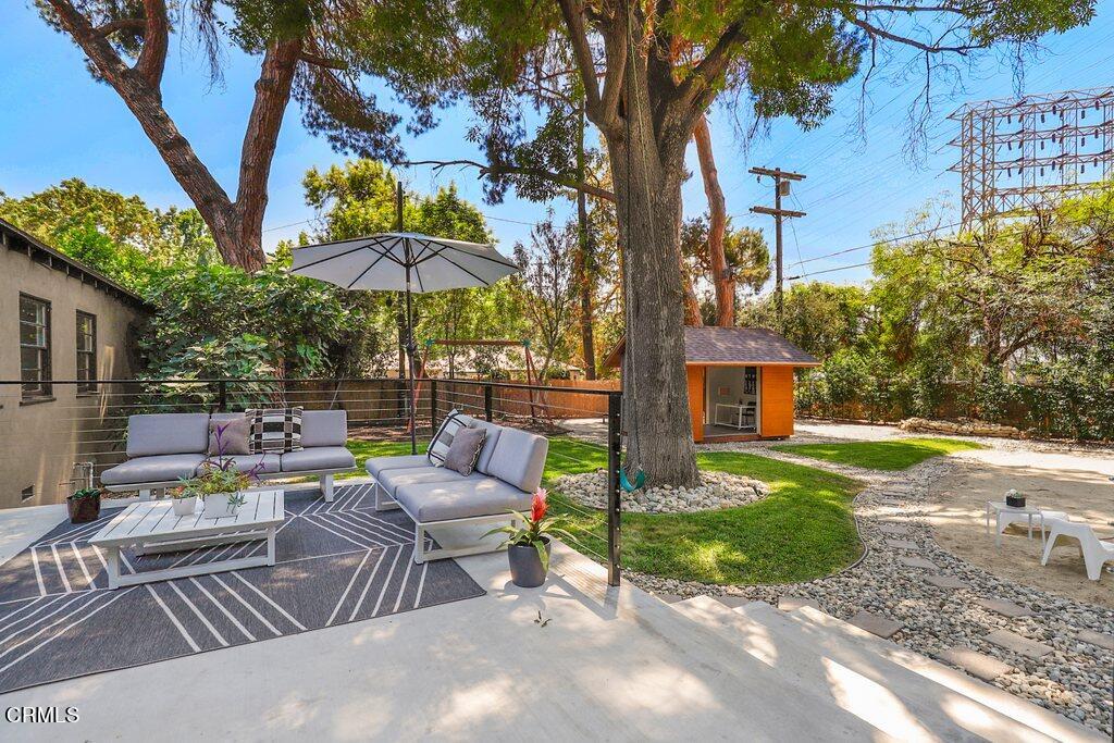 1323 Brampton Road Los Angeles, CA 90041 - Photo 37 of 44 a view of a patio with a table and chairs under an umbrella