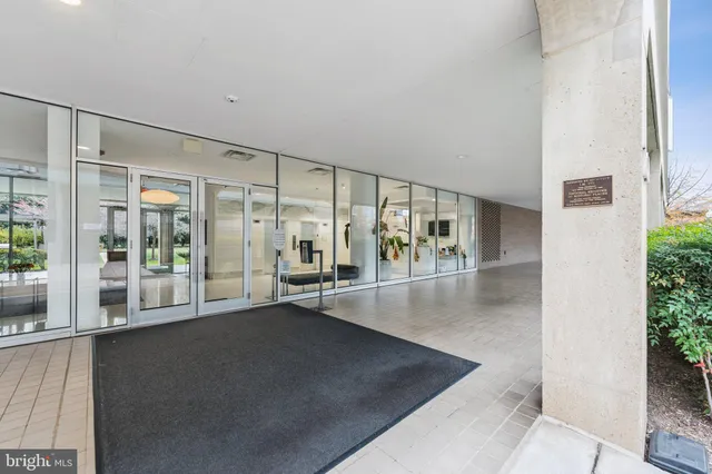 a kitchen with granite countertop a stove a sink dishwasher and white cabinets with wooden floor